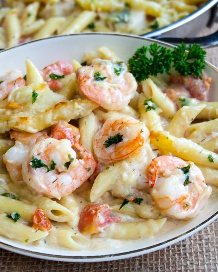 Dish of easy seafood pasta bake topped with herbs and cheese